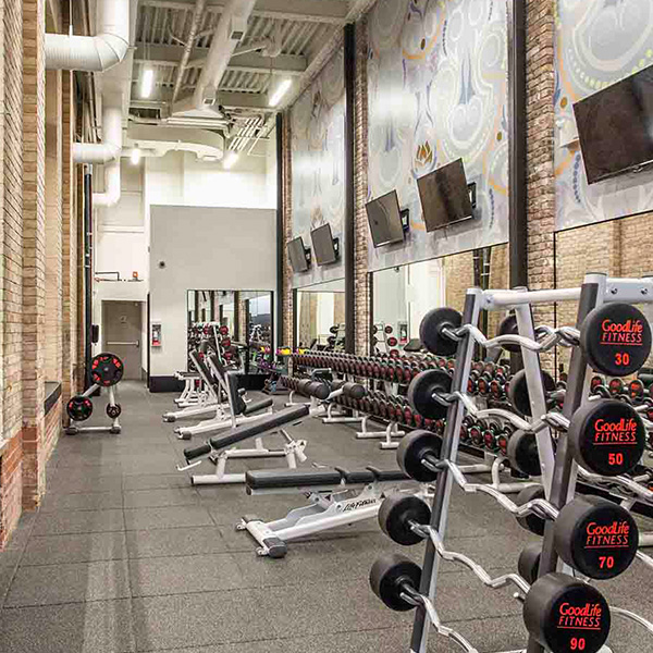 Gym concrete flooring by Flatout Flooring. Sports exercise equipment on concrete floor. A concrete flooring project in London Ontario.